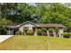 Charming home features a well-maintained lawn, updated siding, and a covered carport for convenient parking at 1875 Fairway Ne Cir, Atlanta, GA 30319