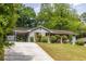 This charming single-story home features a well-manicured front lawn, carport, and an inviting facade at 1875 Fairway Ne Cir, Atlanta, GA 30319