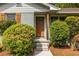Inviting front entrance, framed by lush greenery, leading to a cozy home with classic appeal at 1875 Fairway Ne Cir, Atlanta, GA 30319