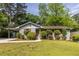 Charming single-story home featuring a well-manicured lawn, inviting curb appeal, and mature trees at 1875 Fairway Ne Cir, Atlanta, GA 30319
