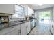 Charming kitchen boasts white cabinetry, granite counters, and stainless steel appliances at 1875 Fairway Ne Cir, Atlanta, GA 30319
