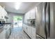 Bright kitchen featuring white cabinets, stainless appliances, and sliding glass doors to the deck at 1875 Fairway Ne Cir, Atlanta, GA 30319