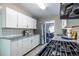 Modern kitchen boasts white cabinets, stainless steel appliances, and granite countertops, perfect for cooking and entertaining at 1875 Fairway Ne Cir, Atlanta, GA 30319