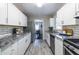 Modern kitchen featuring white cabinets, granite countertops, and stainless steel appliances at 1875 Fairway Ne Cir, Atlanta, GA 30319