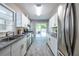 Modern kitchen features white cabinetry, stainless steel appliances, granite countertops, and wood-look flooring at 1875 Fairway Ne Cir, Atlanta, GA 30319