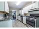 Well-lit kitchen with stainless steel appliances, granite countertops, and white cabinets at 1875 Fairway Ne Cir, Atlanta, GA 30319