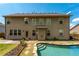 Exterior backyard view featuring a pool and a large two story home at 2022 Boxwood Ln, Canton, GA 30114