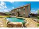 An exterior view of a home featuring a large pool and a well-maintained backyard at 2022 Boxwood Ln, Canton, GA 30114