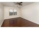 Minimalist bedroom featuring beautiful hardwood floors and a window overlooking a lush outdoor area at 2022 Boxwood Ln, Canton, GA 30114