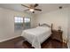 Comfortable bedroom with hardwood floors, ceiling fan, and a large window providing natural light at 2022 Boxwood Ln, Canton, GA 30114
