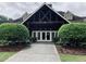 Exterior view of the clubhouse entrance with well-manicured landscaping at 2022 Boxwood Ln, Canton, GA 30114