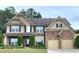 Charming two-story home boasts a stone-accented facade and a well-manicured front yard at 2022 Boxwood Ln, Canton, GA 30114