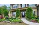 Charming home featuring a landscaped front yard with colorful flowers and manicured evergreens at 2022 Boxwood Ln, Canton, GA 30114