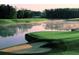 Scenic golf course view with a tranquil lake and pristine green at 2022 Boxwood Ln, Canton, GA 30114