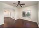 Light-filled living room with dark hardwood floors, ceiling fan, and large window with blinds at 2022 Boxwood Ln, Canton, GA 30114