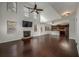 Expansive living room with fireplace, hardwood floors, ceiling fan, and a kitchen view at 2022 Boxwood Ln, Canton, GA 30114