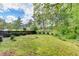 Large back yard with lush green grass and wooded view offers outdoor enjoyment at 3160 Bailey Cove Ct, Dacula, GA 30019