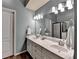 Well lit bath offers dual sinks, large mirror and walk in shower providing spa like experience at 3160 Bailey Cove Ct, Dacula, GA 30019