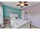 Cozy bedroom with pastel walls, carpet, and a white wood bed under a ceiling fan at 3160 Bailey Cove Ct, Dacula, GA 30019