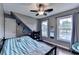 Comfortable bedroom with hardwood floors, large window, and blue striped bedding at 3160 Bailey Cove Ct, Dacula, GA 30019