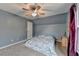 Spacious bedroom with neutral carpet, large window, and ceiling fan at 3160 Bailey Cove Ct, Dacula, GA 30019