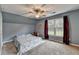 Bedroom with neutral carpet, large window, and ceiling fan at 3160 Bailey Cove Ct, Dacula, GA 30019