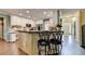 Kitchen island with barstool seating, granite countertops, and white cabinetry at 3160 Bailey Cove Ct, Dacula, GA 30019