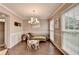 Inviting living room with a modern chandelier, wainscoting, and plenty of natural light at 3160 Bailey Cove Ct, Dacula, GA 30019