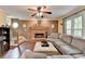 Inviting living room featuring a brick fireplace, hardwood floors, and comfortable seating at 3160 Bailey Cove Ct, Dacula, GA 30019