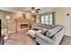 Comfortable living room with brick fireplace, ceiling fan, and large gray sectional at 3160 Bailey Cove Ct, Dacula, GA 30019