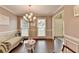 Elegant living room with chandelier lighting, hardwood floors, and large windows providing natural light at 3160 Bailey Cove Ct, Dacula, GA 30019