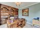 Well-appointed office with a large wooden desk, custom bookshelves, and neutral paint at 3160 Bailey Cove Ct, Dacula, GA 30019