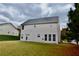 Exterior backyard view of the house with a lush lawn and trees at 5635 Cedar Pass, Fairburn, GA 30213