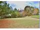 Exterior view of the expansive backyard with a lush green lawn and mature trees at 5635 Cedar Pass, Fairburn, GA 30213