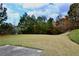 Spacious backyard featuring a well-maintained lawn and lush tree line, creating a serene outdoor space at 5635 Cedar Pass, Fairburn, GA 30213