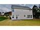 Exterior backyard view of the house with a lush lawn and trees at 5635 Cedar Pass, Fairburn, GA 30213