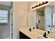 Bathroom with double sink vanity, neutral walls, and a framed mirror over the vanity at 5635 Cedar Pass, Fairburn, GA 30213
