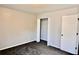 Bright bedroom with gray walls, closet, and carpeting at 5635 Cedar Pass, Fairburn, GA 30213
