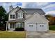 Beautiful two-story home with stone accents, complemented by a well-manicured lawn at 5635 Cedar Pass, Fairburn, GA 30213