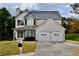 Inviting two-story home featuring stone details and a charming front yard at 5635 Cedar Pass, Fairburn, GA 30213