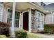 Inviting entryway with stone accents, large windows, and manicured shrubs at 5635 Cedar Pass, Fairburn, GA 30213