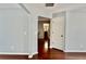 Hallway featuring hardwood floors and neutral paint, leading to other rooms at 5635 Cedar Pass, Fairburn, GA 30213