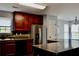 Stylish kitchen with stainless steel appliances, dark cabinets, and granite countertops at 5635 Cedar Pass, Fairburn, GA 30213