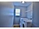 Laundry room featuring a washer, dryer, and wire shelving at 5635 Cedar Pass, Fairburn, GA 30213