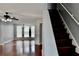 Bright living room with hardwood floors adjacent to a staircase at 5635 Cedar Pass, Fairburn, GA 30213