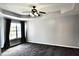 Main bedroom features tray ceiling, fan, and large window at 5635 Cedar Pass, Fairburn, GA 30213