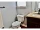 Clean and modern powder room featuring granite counter and dark cabinetry at 5635 Cedar Pass, Fairburn, GA 30213