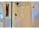 Shower featuring glass doors and updated fixtures against neutral tile and wall accents at 5635 Cedar Pass, Fairburn, GA 30213