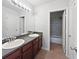 Bathroom with double sink vanity, granite countertops and walk-in shower with white doors and trim at 7155 Homestead Rd, Rex, GA 30273