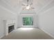 Carpeted primary bedroom with tray ceilings, fireplace and neutral colors at 7155 Homestead Rd, Rex, GA 30273